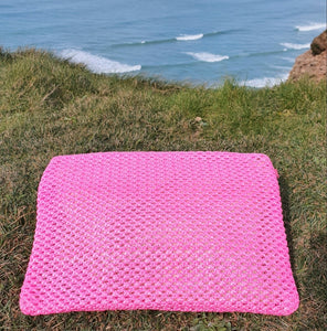 Bright pink rattan clutch bag